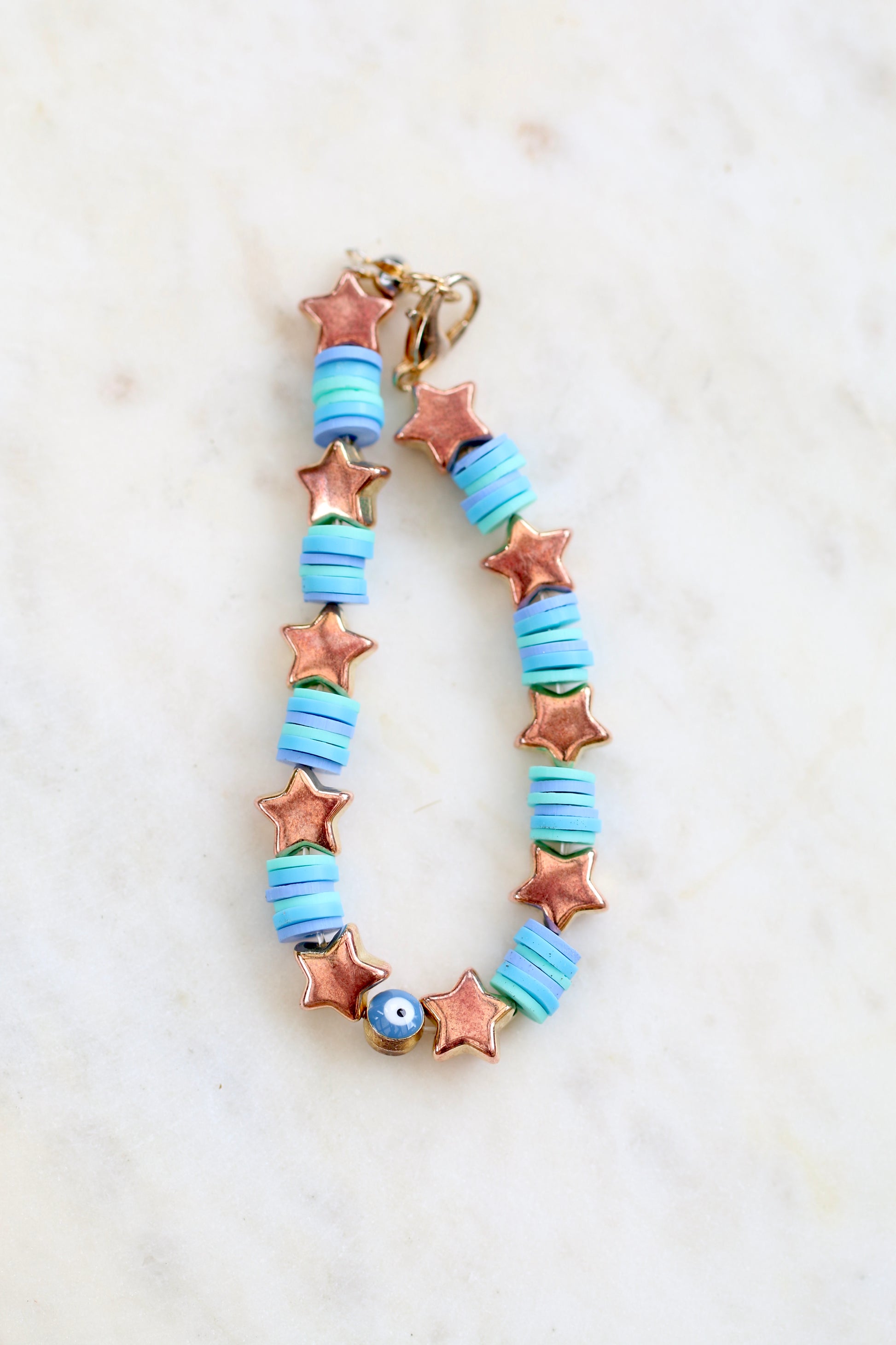 bright blue bracelet with stars on a white background