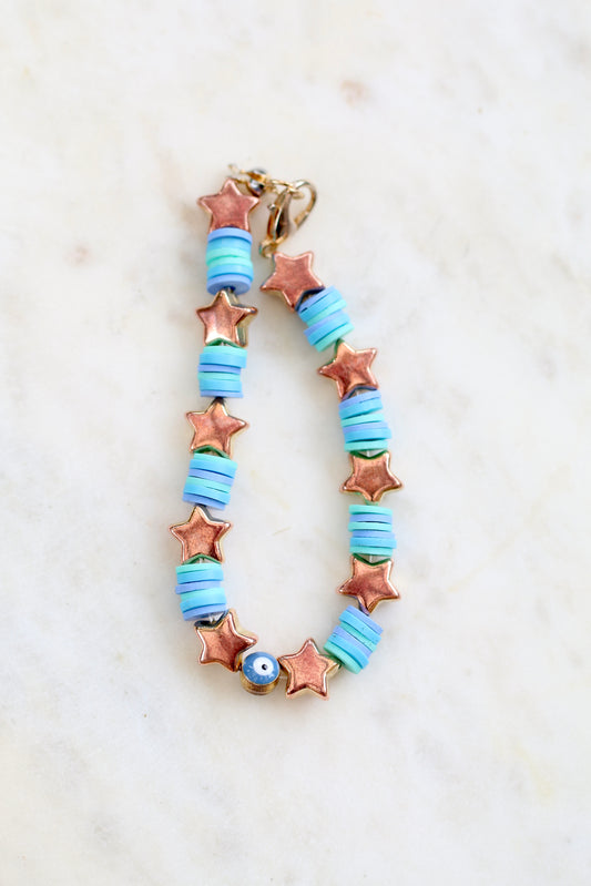 bright blue bracelet with stars on a white background